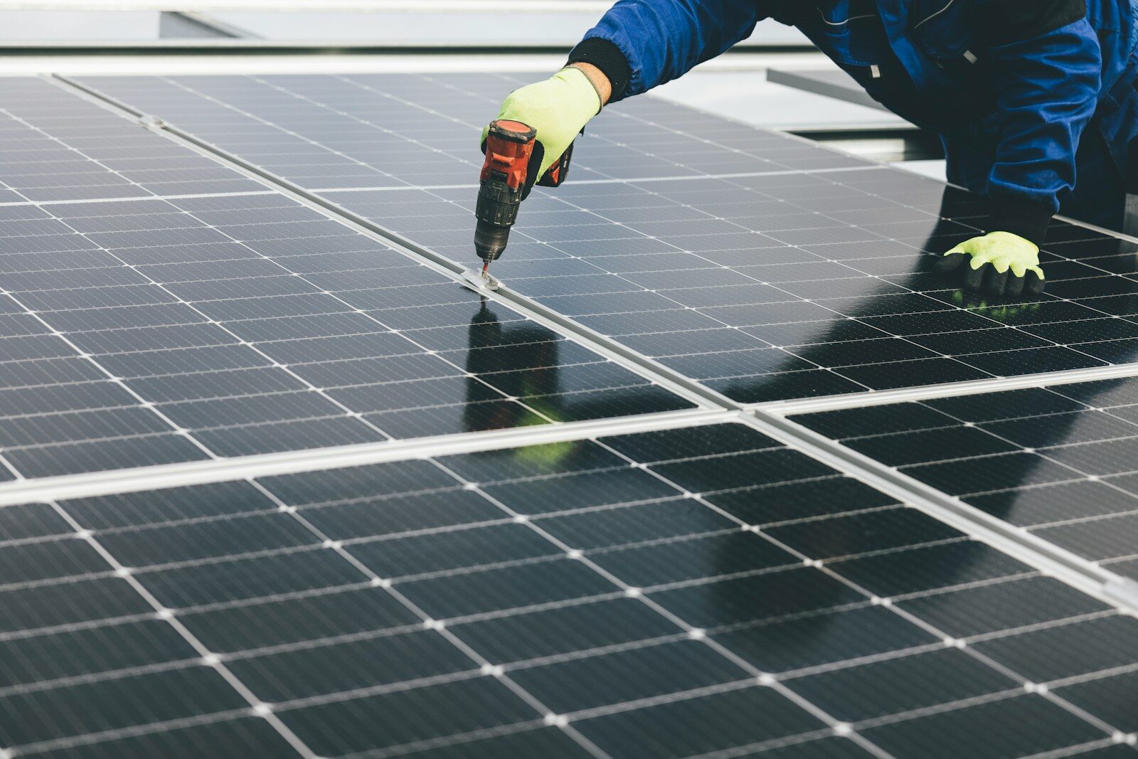 Photo by Markus Spiske a person working on a solar panel